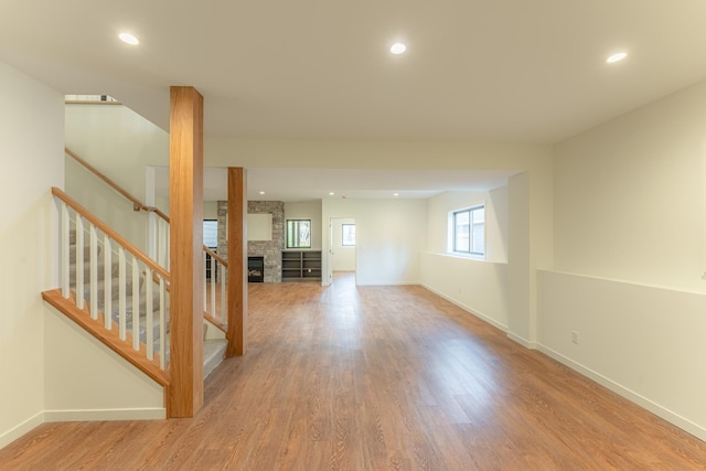 interior space featuring a stone fireplace and wood-type flooring