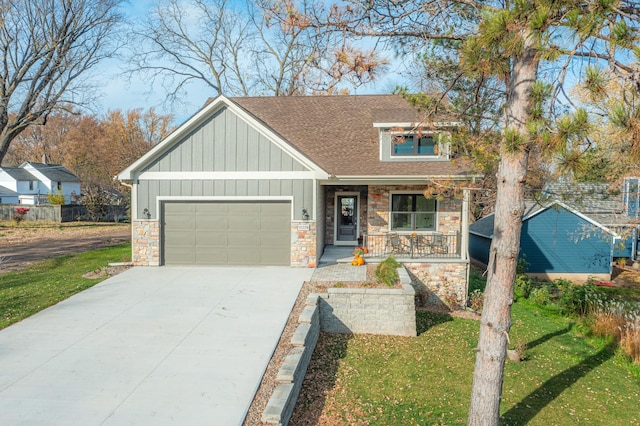 craftsman house featuring a porch, a garage, and a front lawn