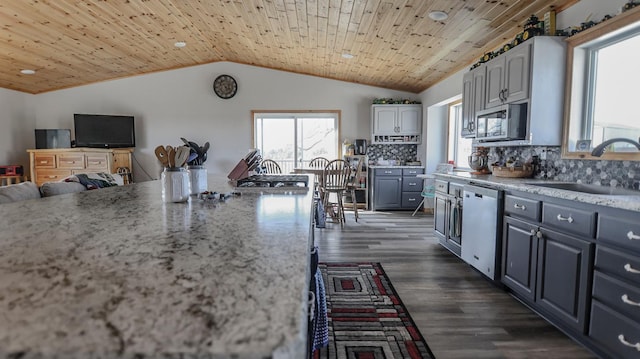 kitchen featuring white cabinets, appliances with stainless steel finishes, sink, and wooden ceiling