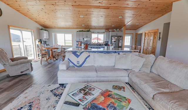 living room with hardwood / wood-style flooring, vaulted ceiling, and wooden ceiling