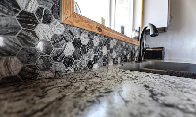 room details featuring sink and decorative backsplash