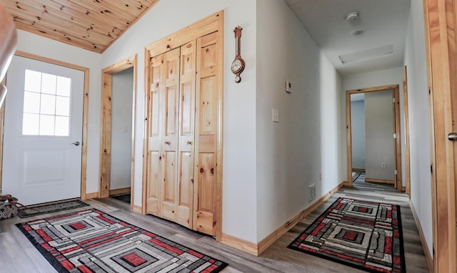 corridor with vaulted ceiling, wood ceiling, and light hardwood / wood-style floors