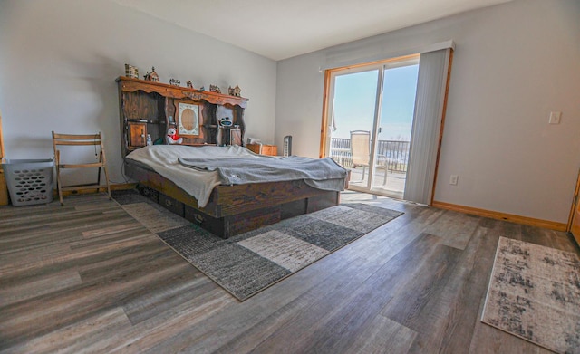 bedroom with dark wood-type flooring and access to outside