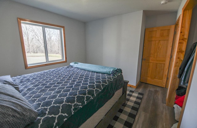 bedroom with dark wood-type flooring