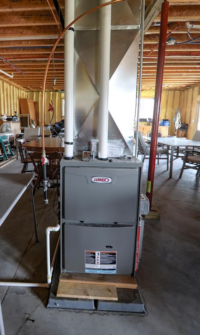 utility room featuring heating unit