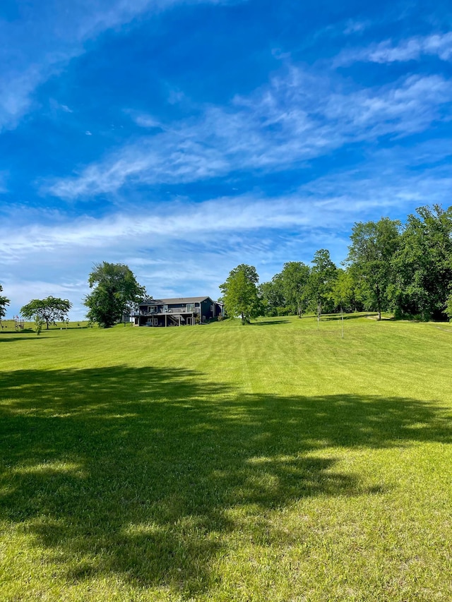 view of community featuring a rural view and a lawn