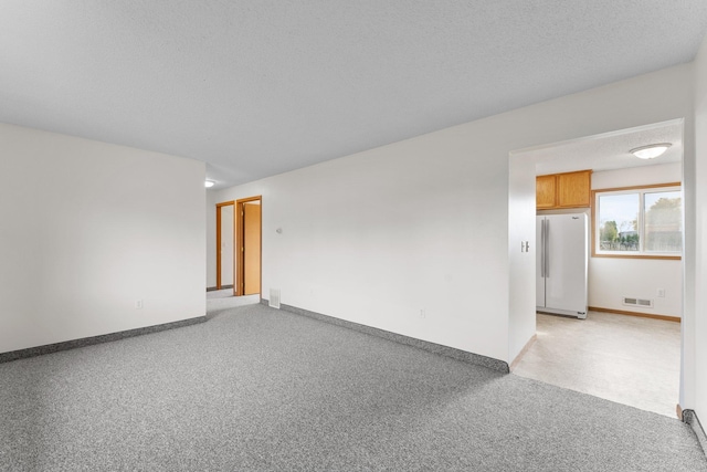 spare room with a textured ceiling