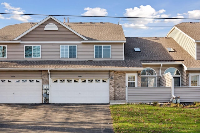 view of front facade with a garage and a front lawn