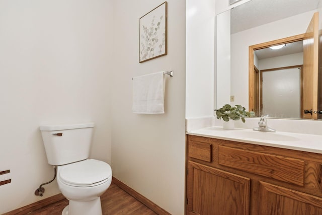 bathroom with vanity, hardwood / wood-style floors, and toilet