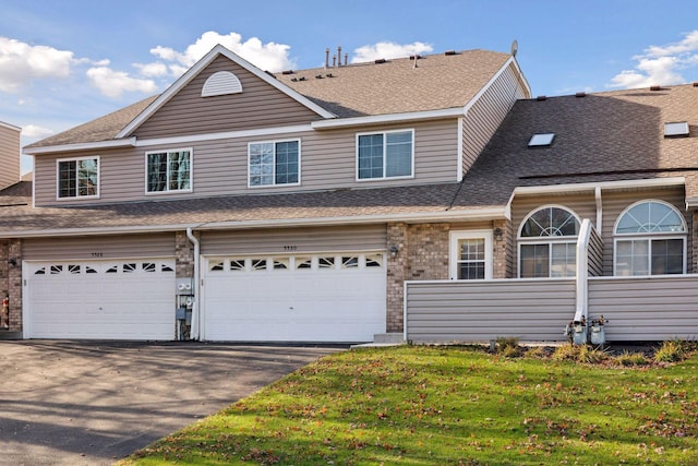 view of front of home with a garage and a front lawn