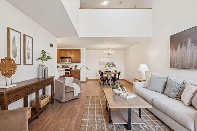 living room featuring dark hardwood / wood-style flooring and a notable chandelier