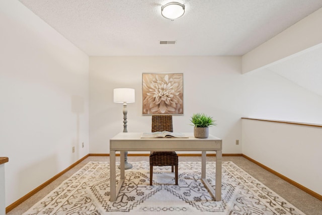 carpeted office space featuring lofted ceiling with beams and a textured ceiling