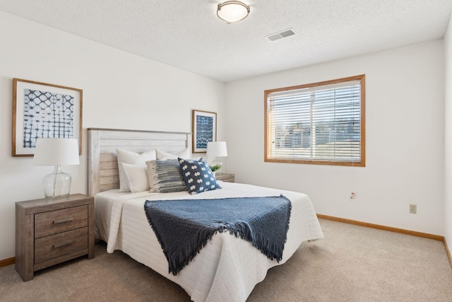 carpeted bedroom with a textured ceiling