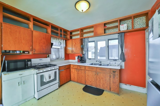 kitchen with white range with gas stovetop and sink