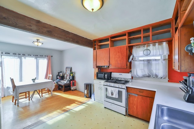 kitchen with light hardwood / wood-style flooring and gas range gas stove