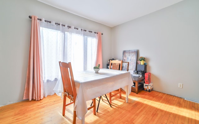 dining space with light wood-type flooring