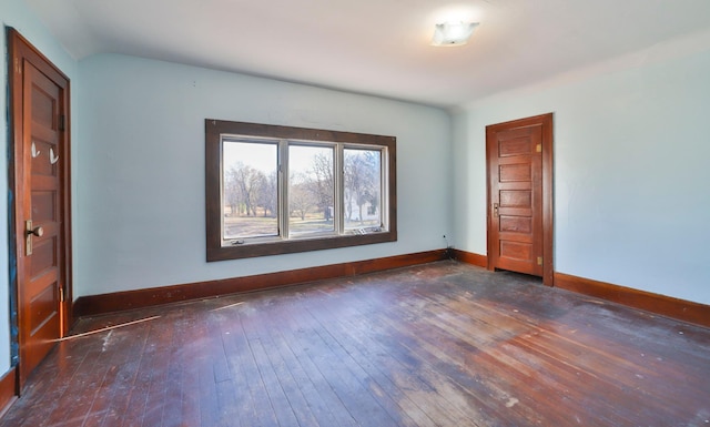 spare room featuring dark wood-type flooring