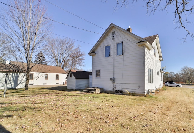 rear view of property with a lawn