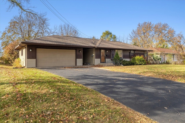 ranch-style home with a front lawn and a garage