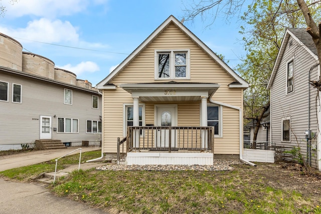 shotgun-style home with covered porch and entry steps