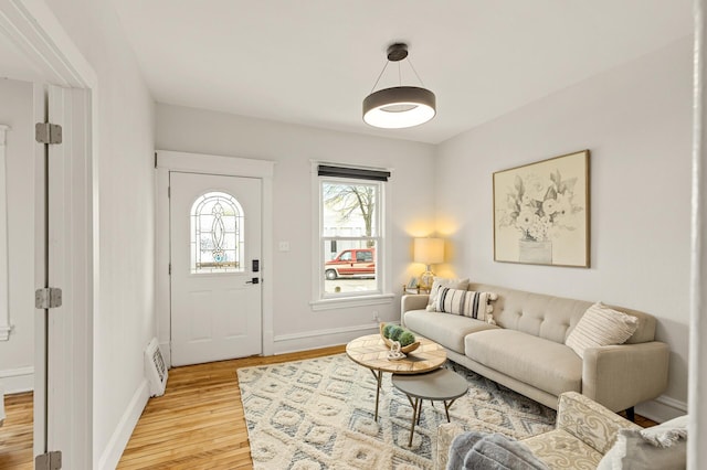 living area with baseboards and light wood-type flooring