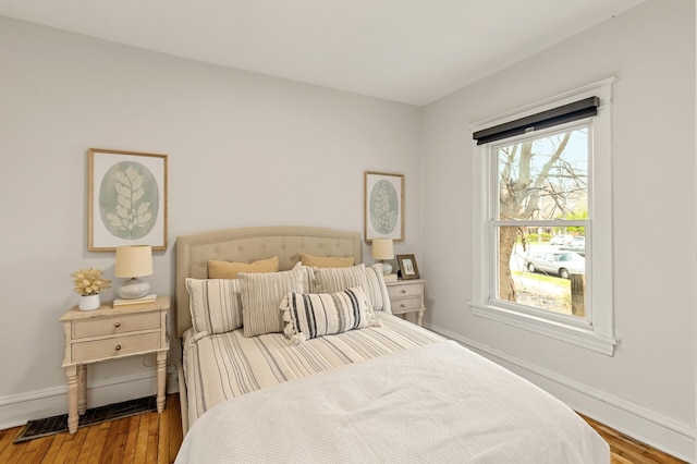 bedroom featuring baseboards and wood finished floors