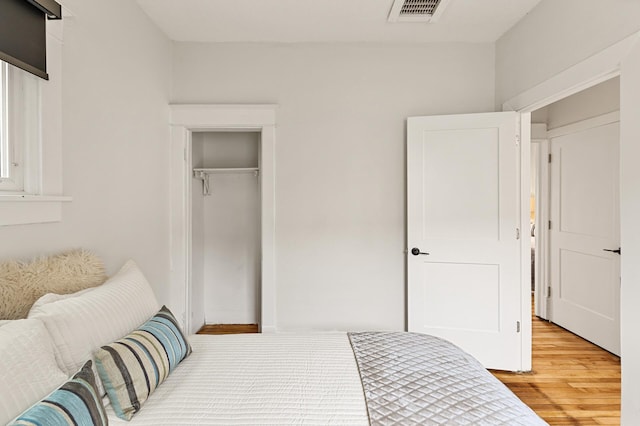 bedroom featuring visible vents, a closet, and light wood-type flooring