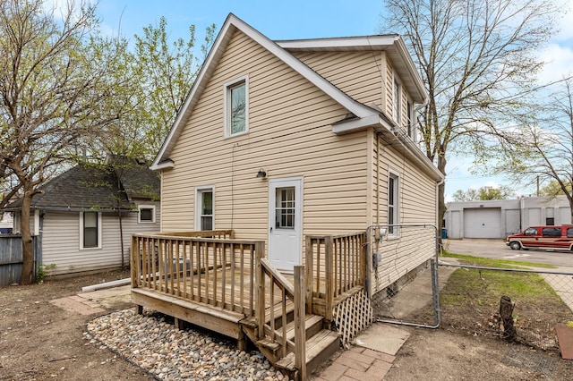 back of house featuring a wooden deck