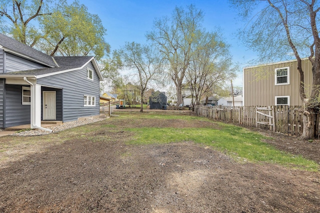 view of yard featuring fence and a residential view