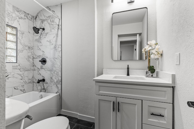 bathroom with toilet, baseboards, tile patterned floors, vanity, and tub / shower combination
