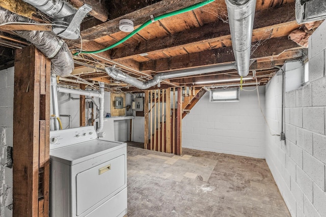 basement with stairs, washer / dryer, and electric panel