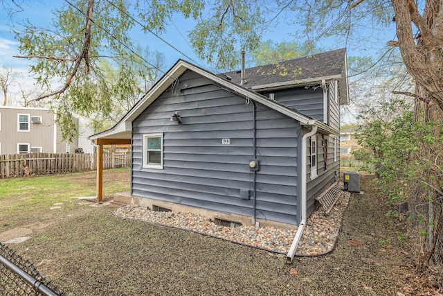 exterior space featuring cooling unit, a shingled roof, and fence