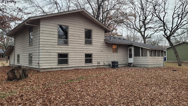 back of house with a sunroom and central AC