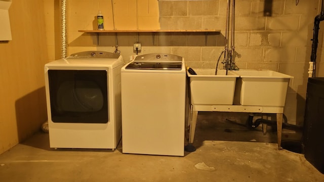 clothes washing area with sink and independent washer and dryer