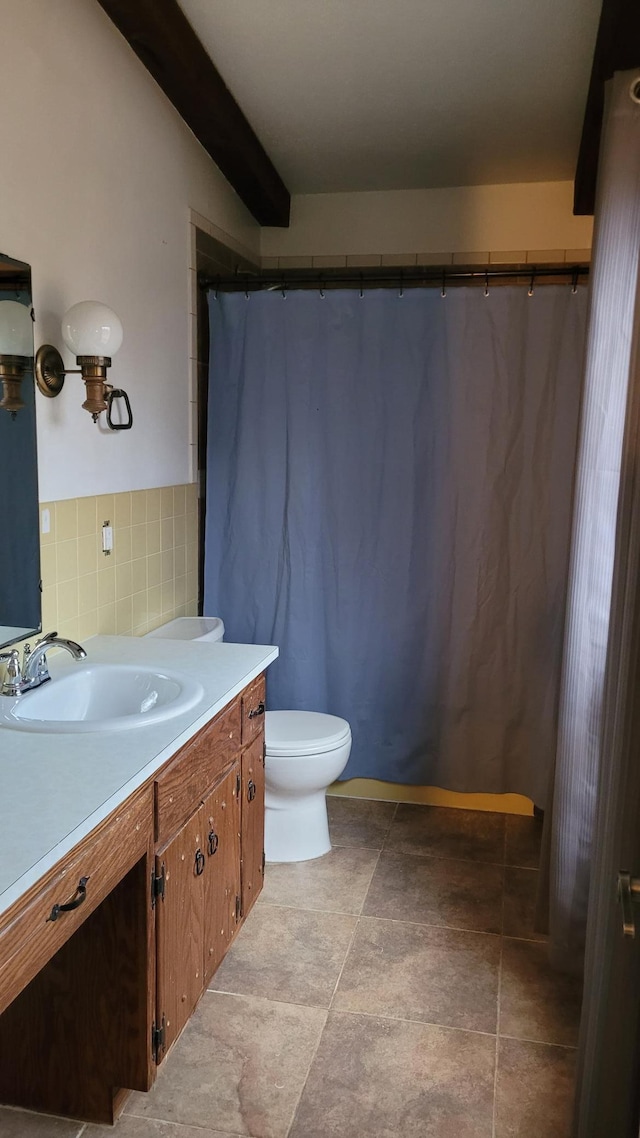 bathroom with tile patterned floors, vanity, toilet, and backsplash