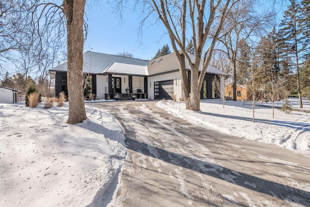 view of front of property with an attached garage and stucco siding