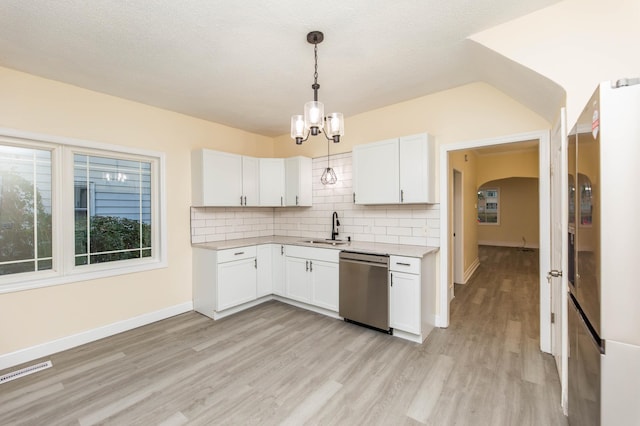 kitchen with stainless steel appliances, hanging light fixtures, sink, light hardwood / wood-style floors, and white cabinets