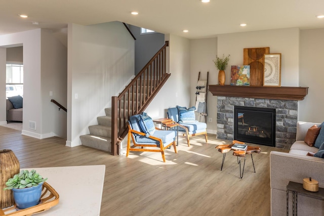 living room featuring a fireplace and light wood-type flooring