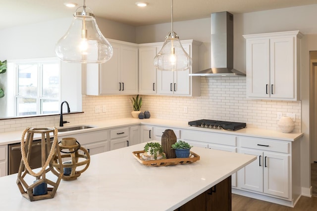 kitchen with tasteful backsplash, appliances with stainless steel finishes, and wall chimney exhaust hood