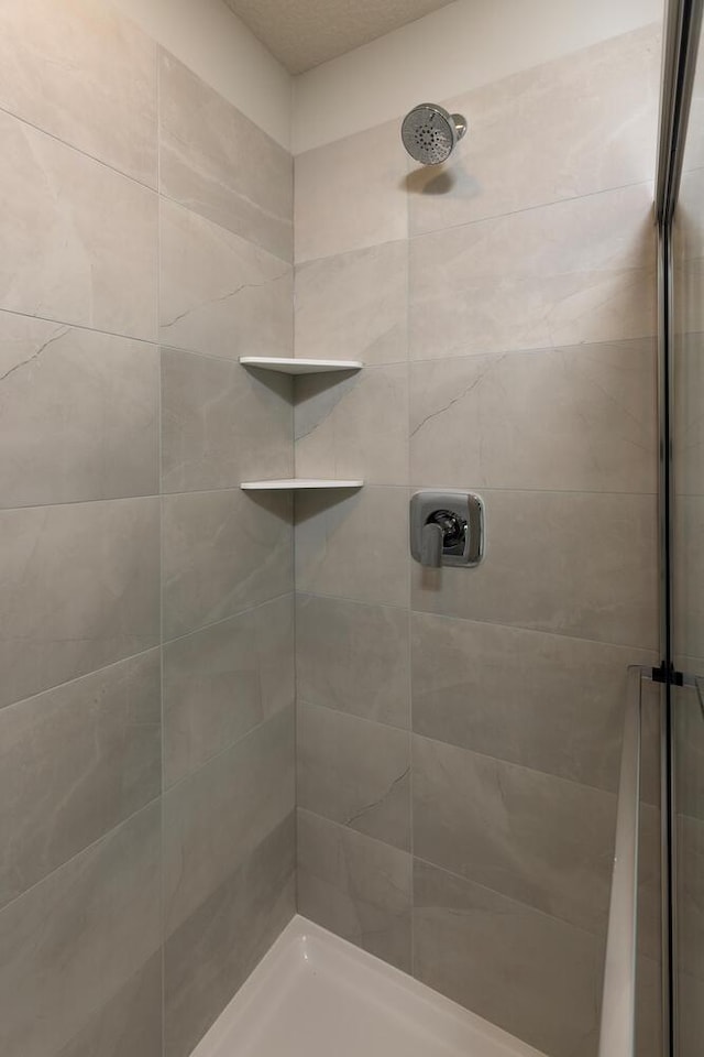 bathroom with tiled shower