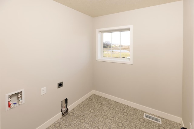 laundry area with washer hookup, electric dryer hookup, and a textured ceiling