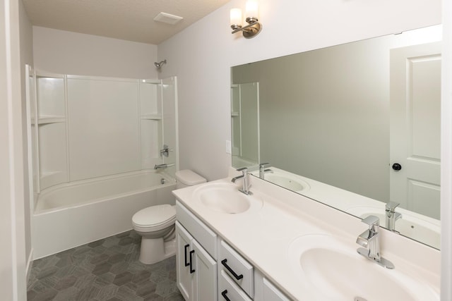 full bathroom with vanity, a textured ceiling, toilet, and bathtub / shower combination