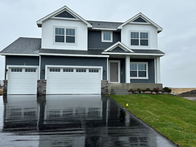 view of front of home with a garage and a front lawn