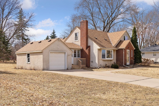 view of front of house with driveway, roof with shingles, an attached garage, stucco siding, and a chimney