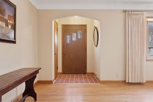 entrance foyer featuring baseboards and light wood-style flooring