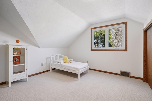 bedroom featuring light colored carpet, visible vents, and baseboards