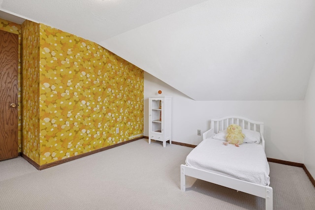 bedroom with baseboards, carpet flooring, and vaulted ceiling