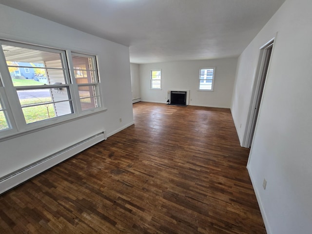 unfurnished living room with dark hardwood / wood-style floors and a baseboard radiator