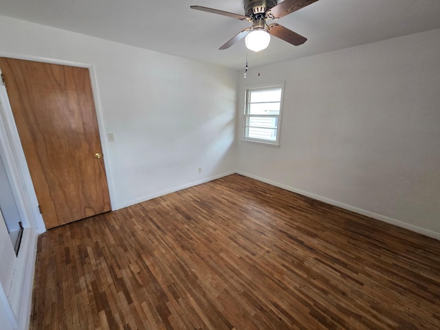 unfurnished room featuring dark wood-type flooring and ceiling fan