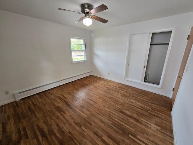 unfurnished bedroom with dark hardwood / wood-style flooring, a closet, ceiling fan, and a baseboard heating unit